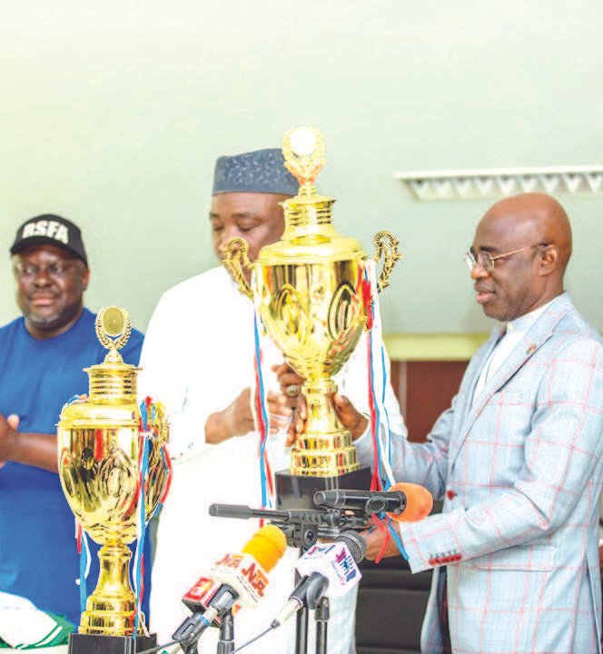 NFF President, Ibrahim Gusau presenting the trophy to the Benue Governor